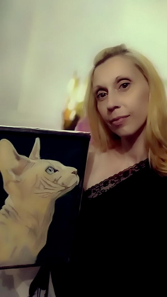 The cat looks at the mistress who applies anti-wrinkle cream