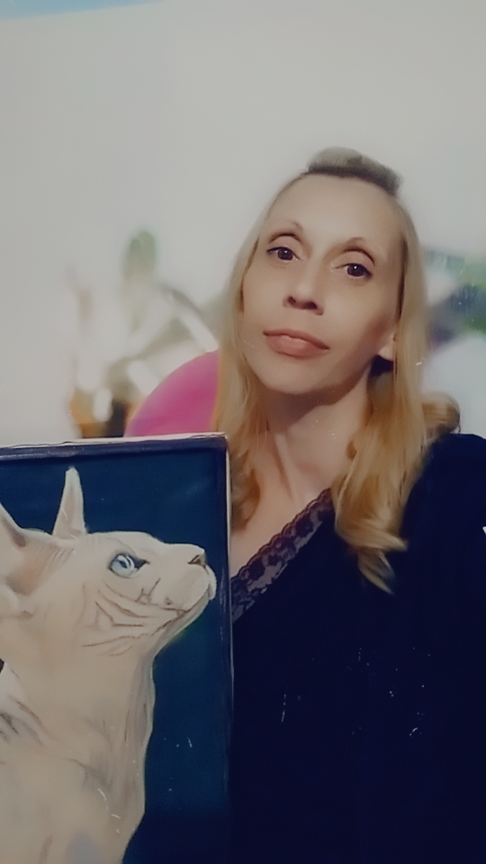 The cat looks at the mistress who applies anti-wrinkle cream